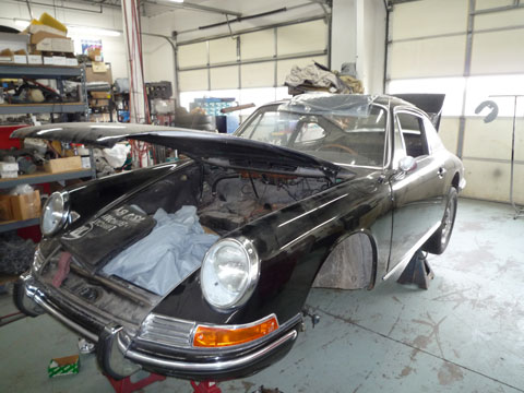 Image of classic black porsche being repaired.