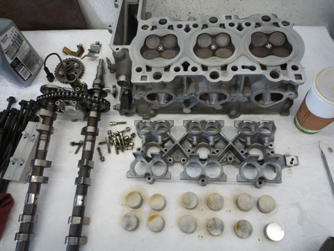 Image of an engine's cylinder head being built.